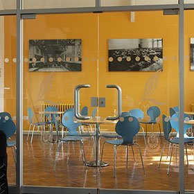 Internal glass double doors looking through to a canteen